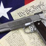 handgun laying on constitution & flag