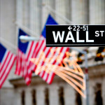 Wall Street sign with US flags