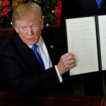 U.S. President Donald Trump displays an executive order after he announced the U.S. would recognize Jerusalem as the capital of Israel, in the Diplomatic Reception Room of the White House in Washington