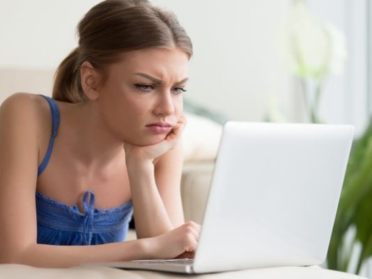 frustrated-looking-young-woman-looking-at-laptop-computer