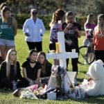 parkland students mourn at a cross