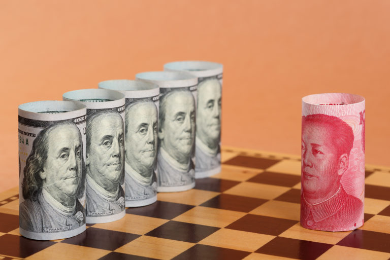 Chinese Money Notes vs US Money Note on a Chess Board