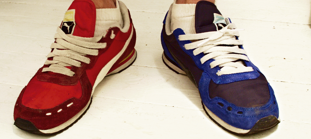 one blue shoe and one red shoe