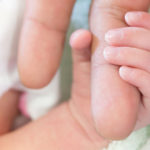 Newborn-baby-hand-around-Adult-Parent-finger