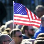 Trump supporter waves american flag