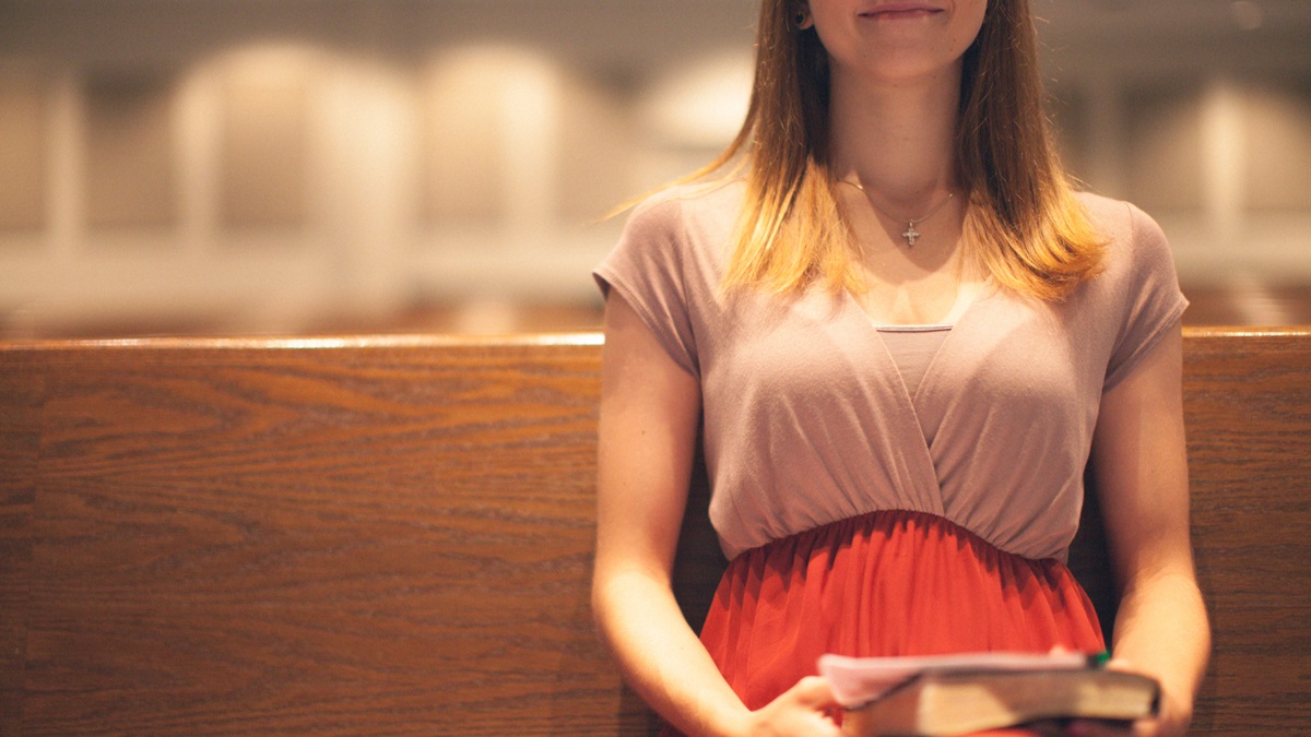 young woman in a pew in church