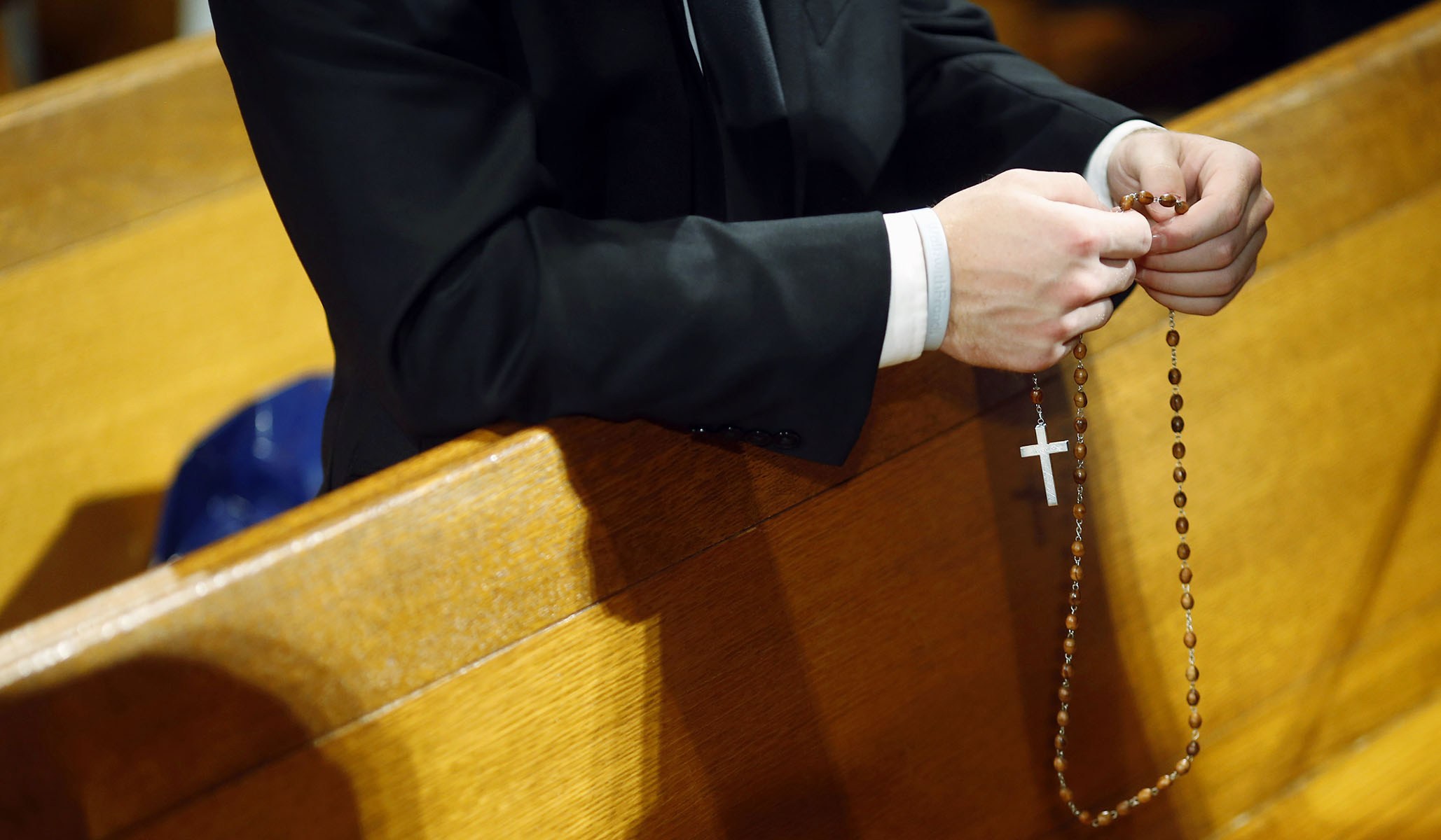 Man prays the rosary