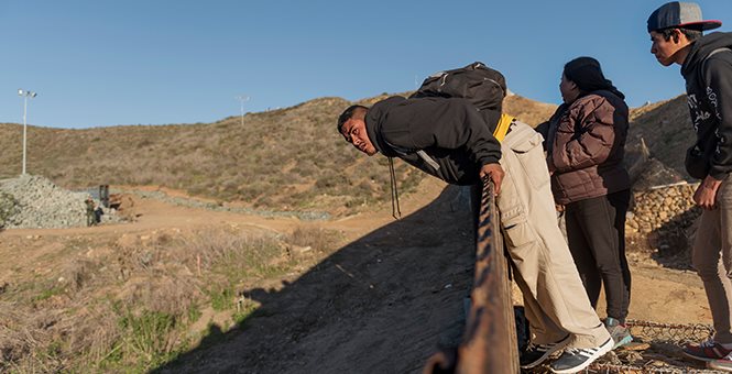 Illegal Immigrants go over wall