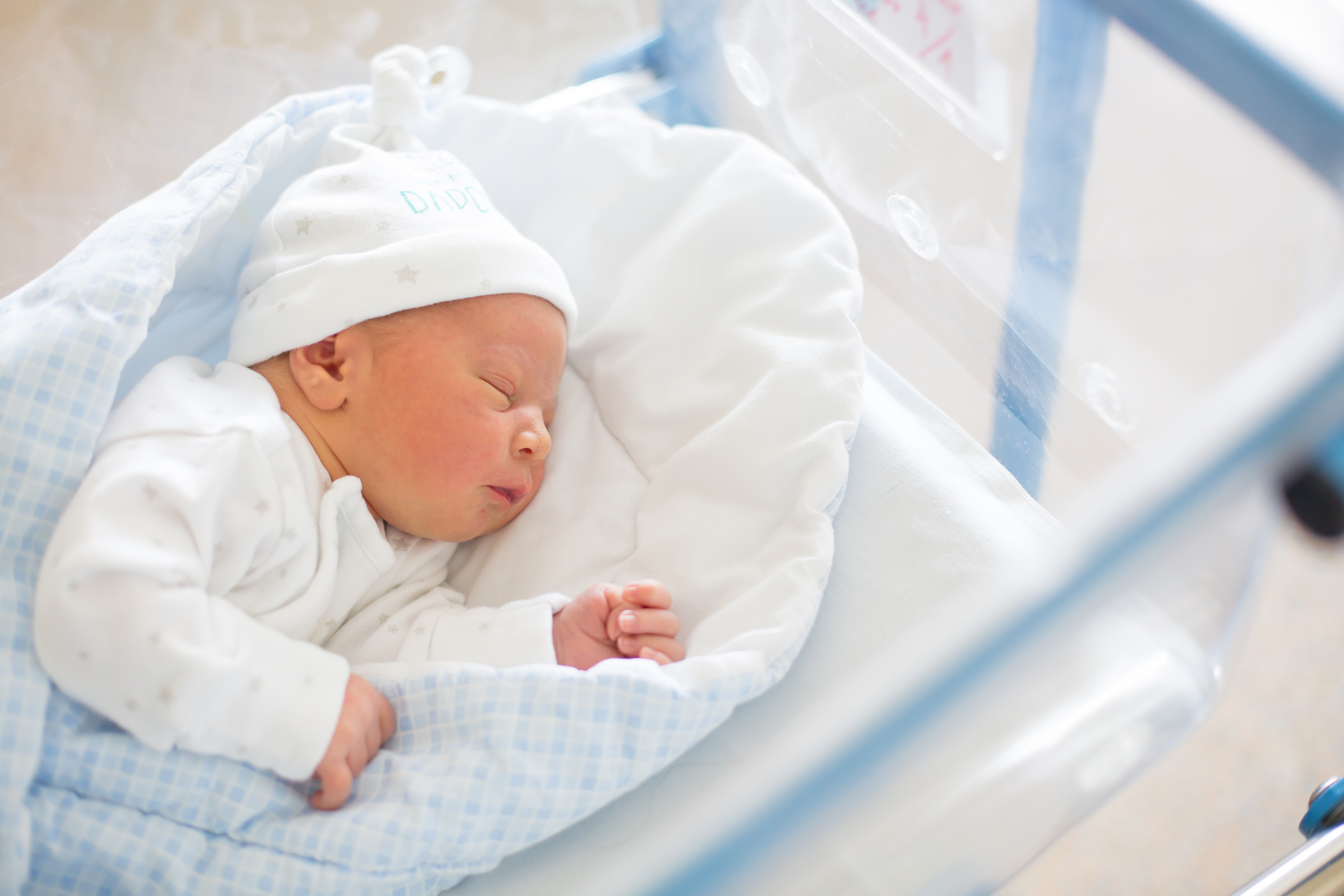 Newborn baby in crib in prenatal hospital