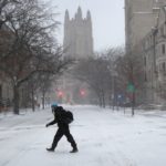 Student crosses snowy street