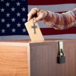 Voter w/ cross inserting-ballot-into-ballot-box