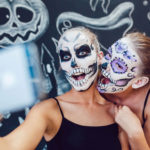 2 girls in skeleton face paint