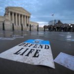 Defend Life poster on steps of SCOTUS bldg