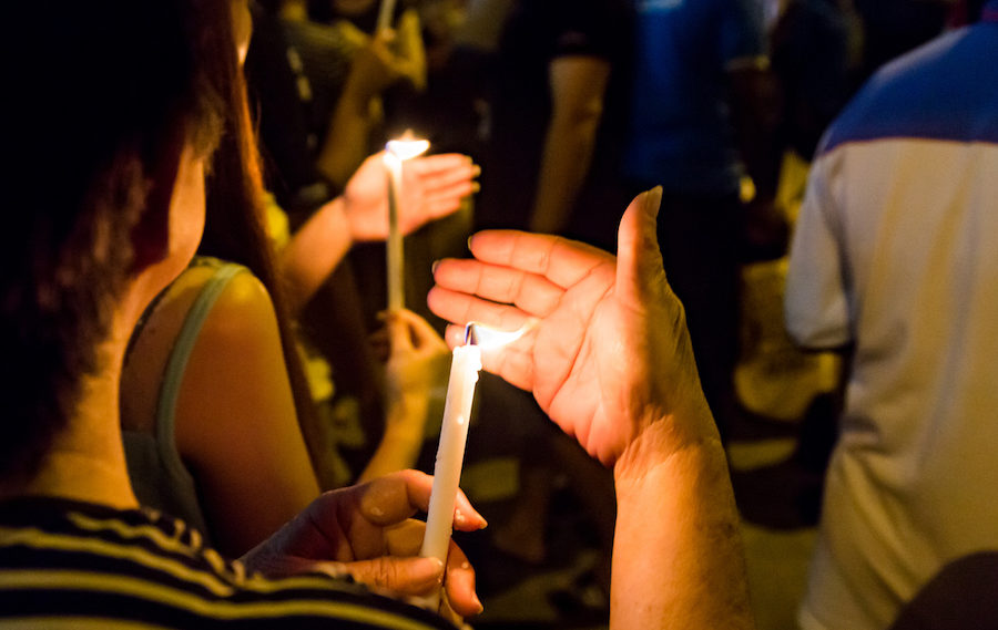 People holding candle vigil