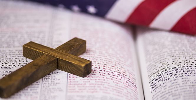 cross on Bible on US flag