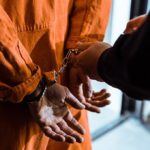 prisoner in jail being handcuffed