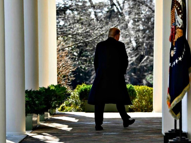 Coated President Trump walks on White House Porch
