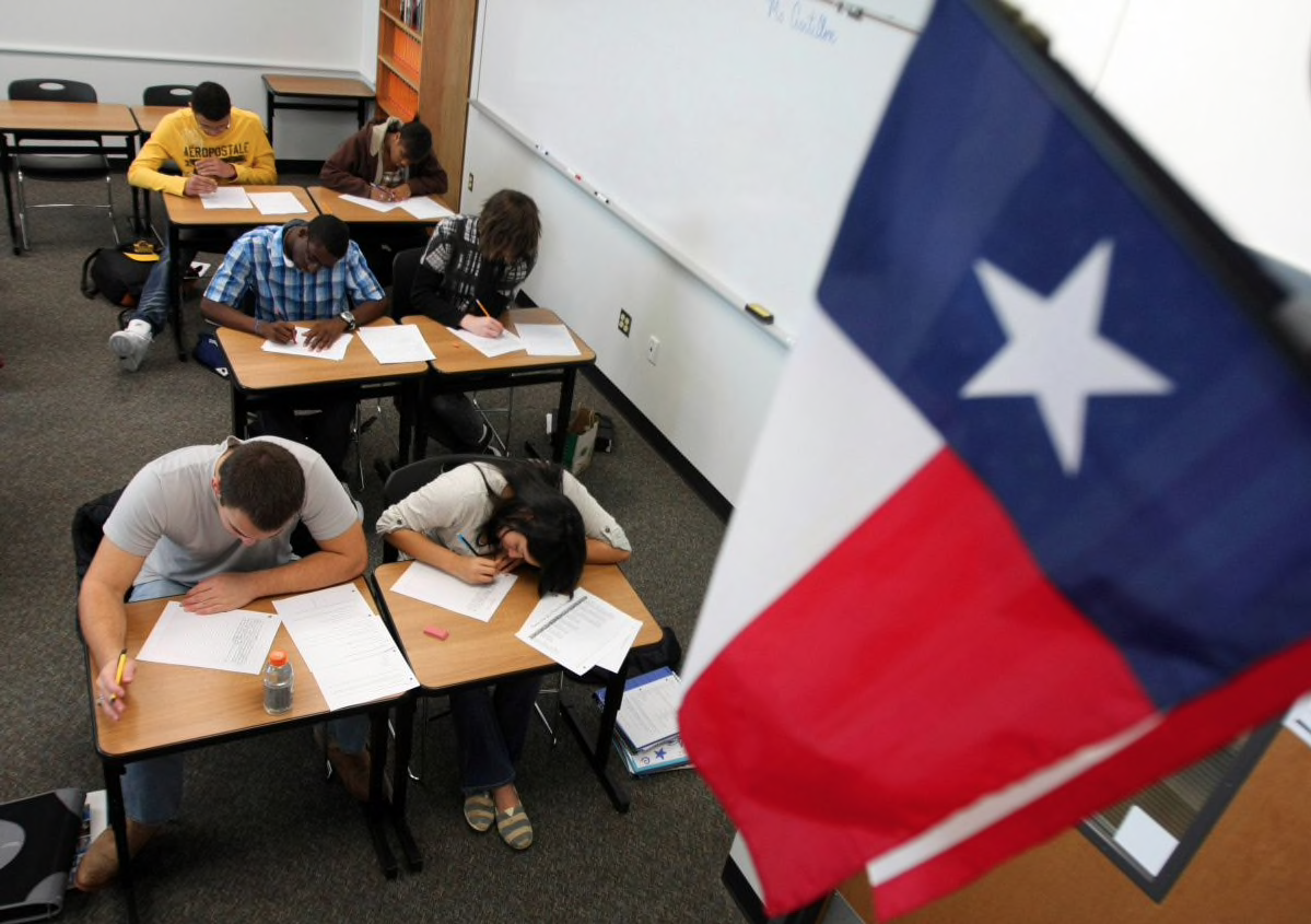 Students taking test under Texas flag