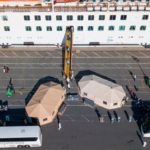 Passengers disembark cruise ship into quarantine tents