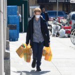 man on sidewalk w groceries & mask