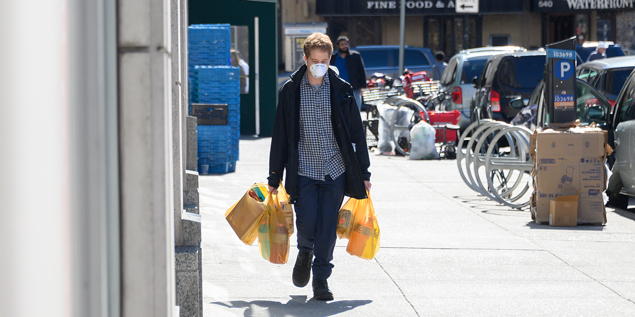man on sidewalk w groceries & mask