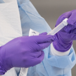 masked gloved lab worker