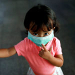 Little girl in Bangkok wearing mask
