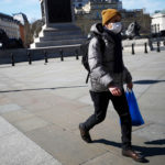 man wears a mask in Trafalgar Square