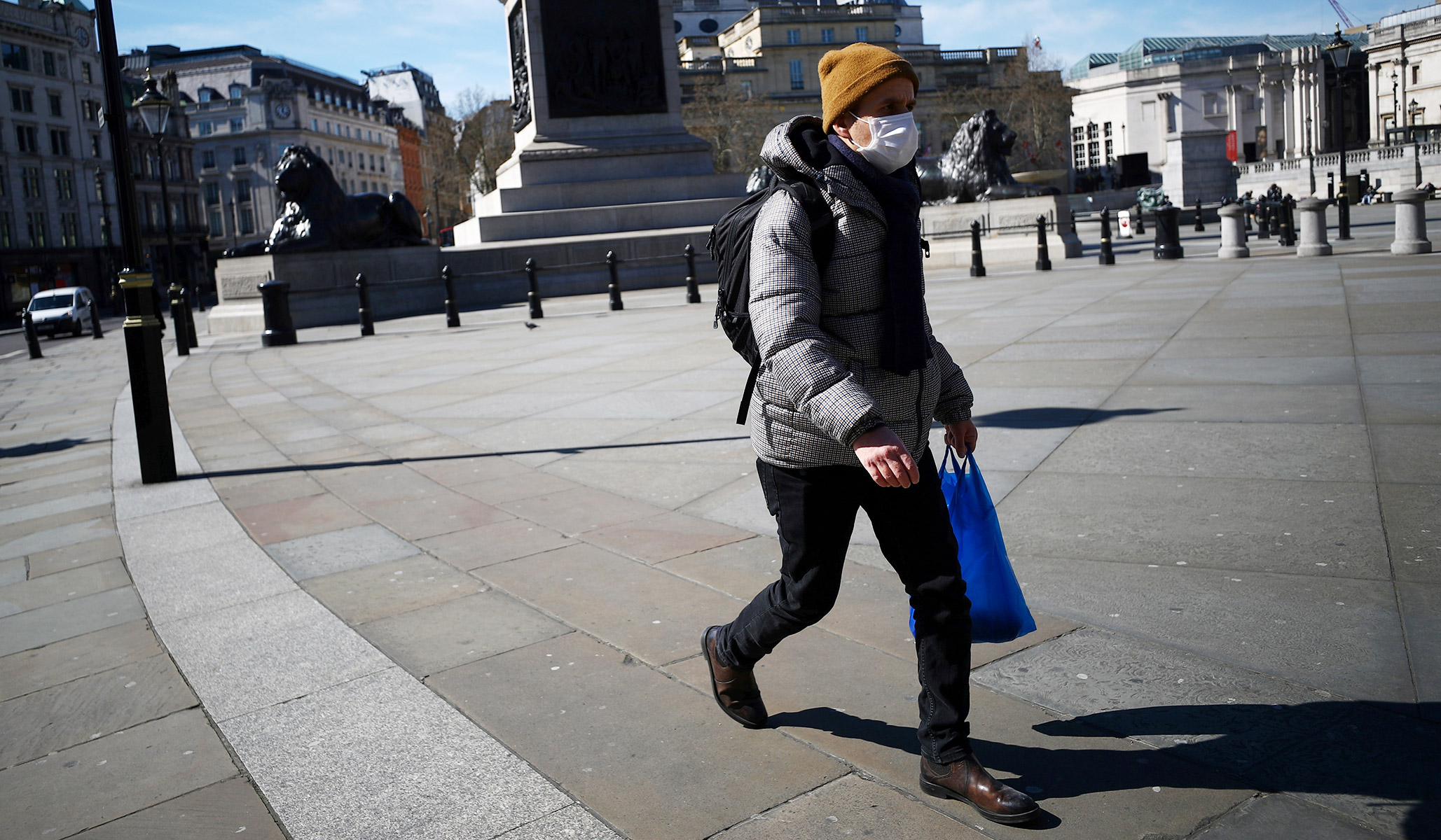 man wears a mask in Trafalgar Square