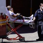 NY-emt-patient loaded into ambulance