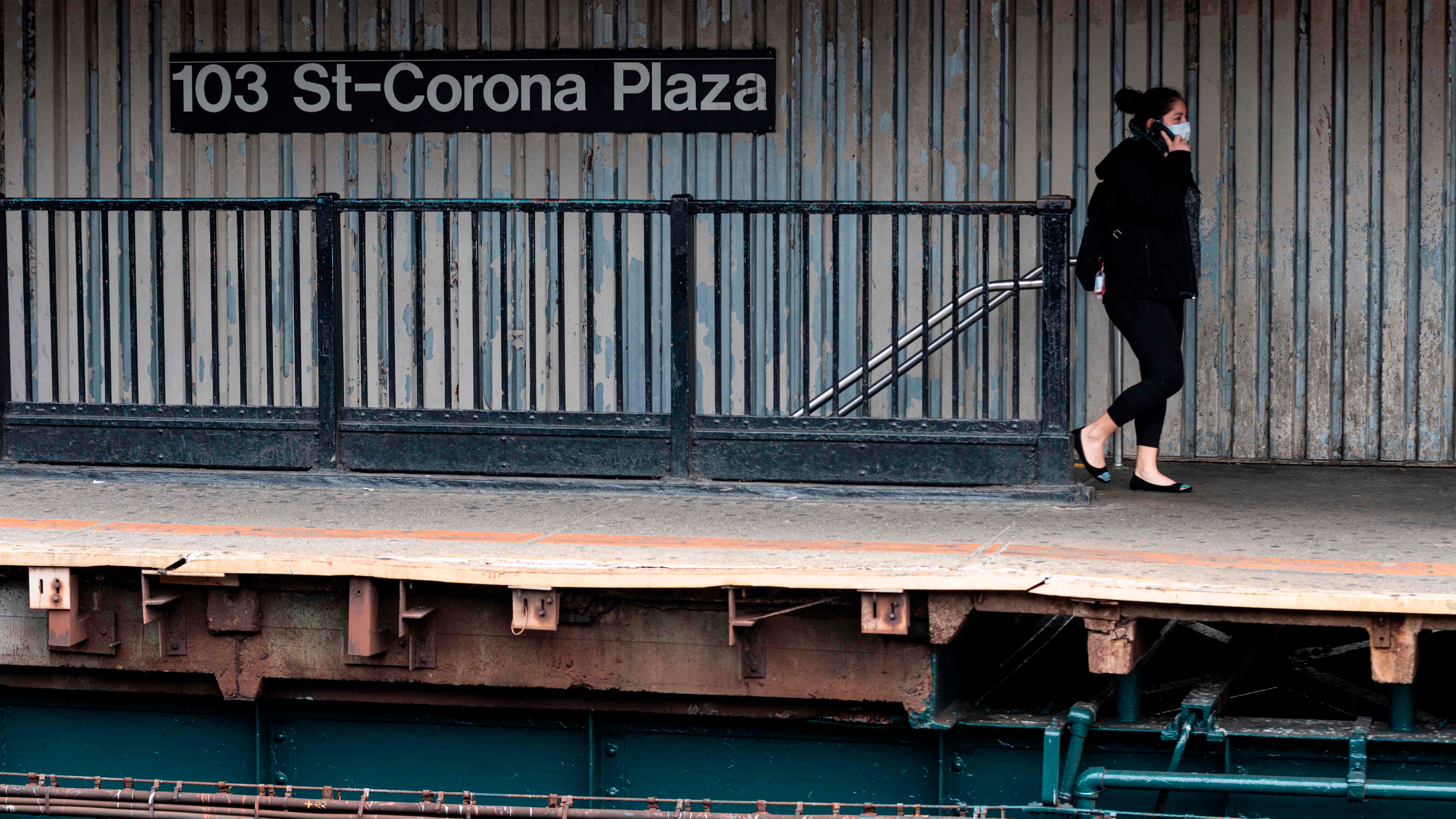 Lone woman in mask on train platform