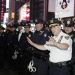 NYPD Officers along barricade of protesters.jpg