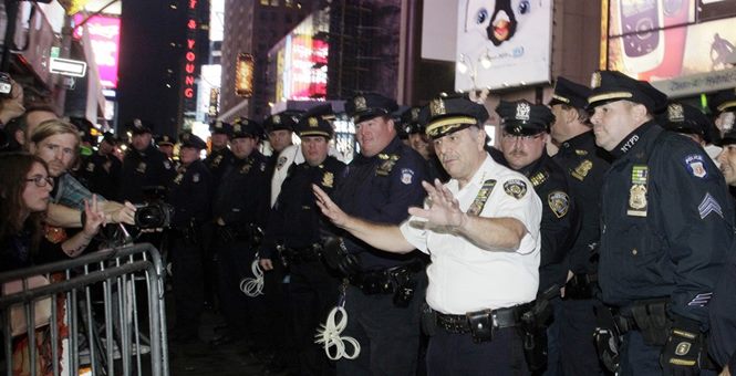 NYPD Officers along barricade of protesters.jpg