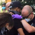 Nashville police officer prays with protestor