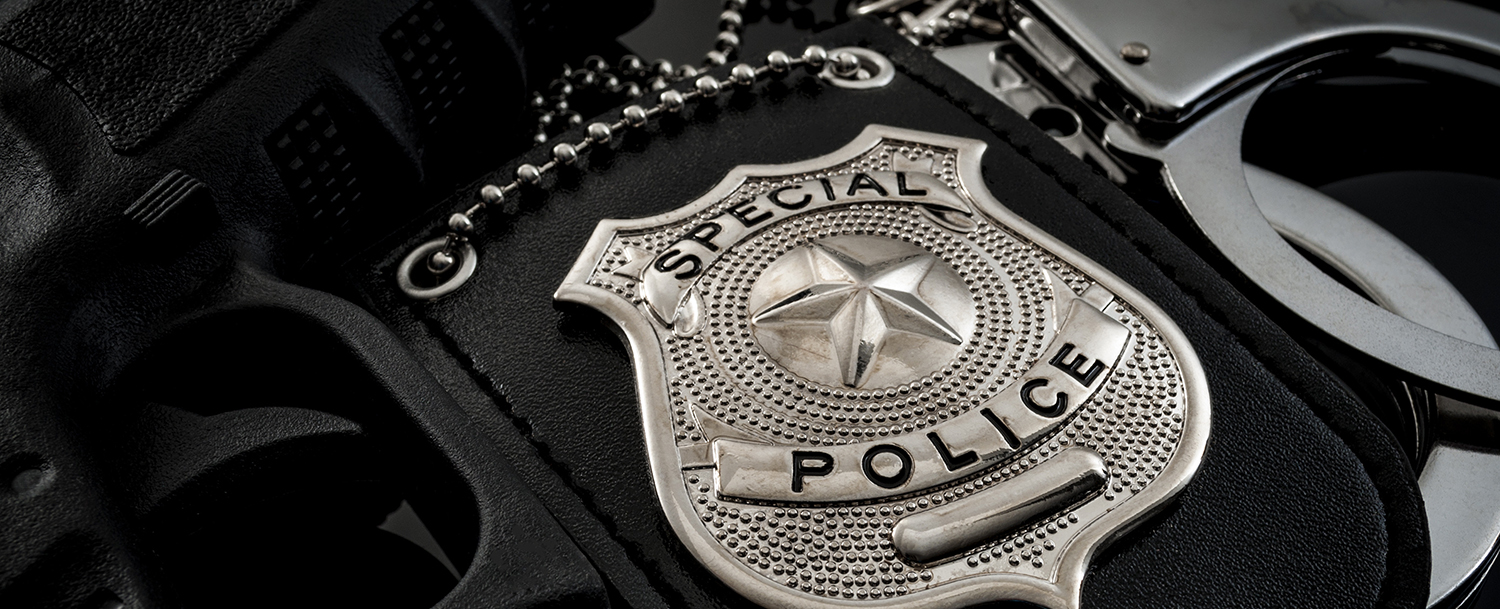 Police badge, gun, cuffs