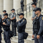 Police stand in rows on steps