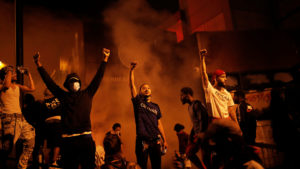Protesters gather after setting fire to a police station in Minneapolis