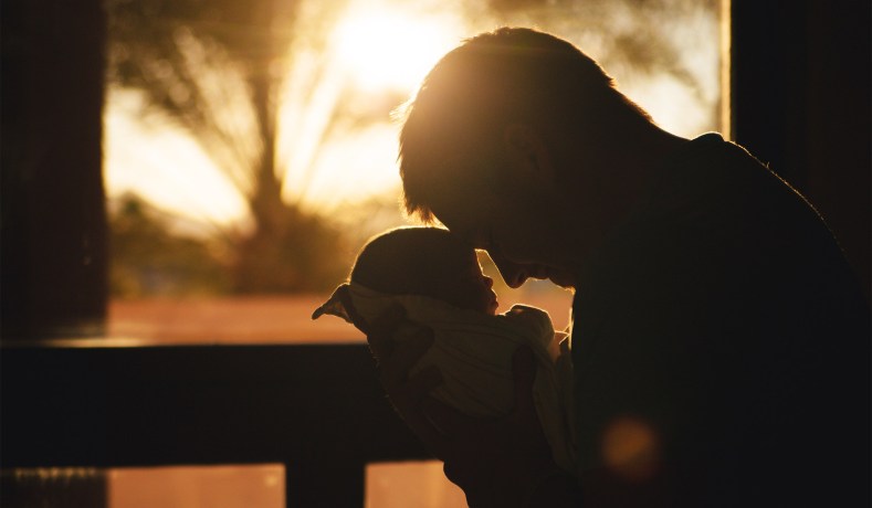 father-holding-baby-backlit