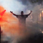 Open armed man in tear gas