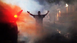 Open armed man in tear gas