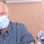 Masked Old person getting vaccine
