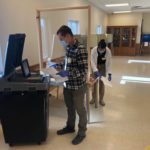 Poll workers cleaning