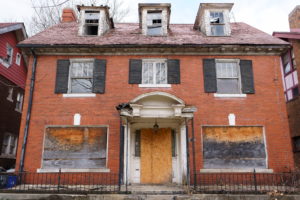 Urban-Poverty-abandoned-boarded-brick-house