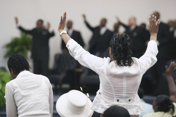 Worshippers in church - raised hands