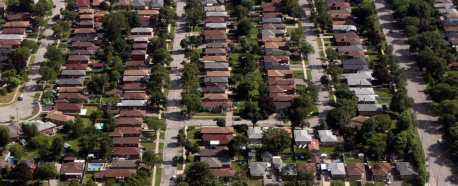 Arial view of house rooftops and city blocks near Toronto and su