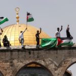 palestinians celebrate on Temple Mount wall