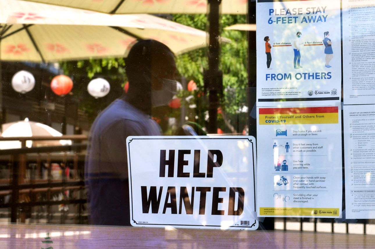 Help Wanted sign in business window
