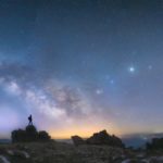 hiker on rock w milky way