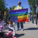 protestor - upside down US type flag w rainbow stripes