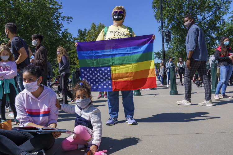 protestor - upside down US type flag w rainbow stripes